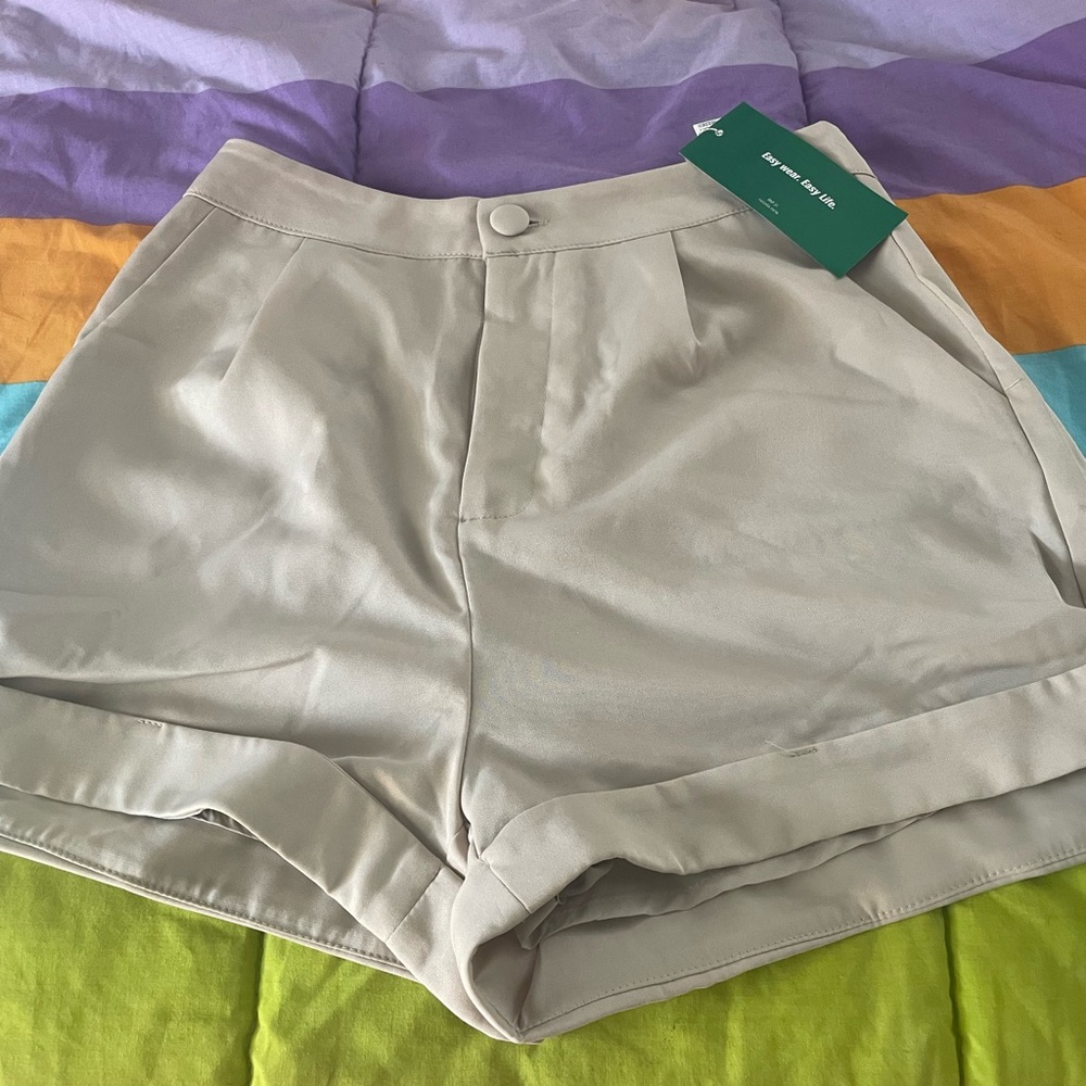 Shorts by SHEIN.   Brand new light cream color with packets polyester.